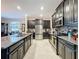 Gourmet kitchen featuring granite counters, stainless steel appliances, dark wood cabinetry and tile flooring at 32101 Goddard Dr, Wesley Chapel, FL 33543