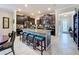 Spacious kitchen featuring dark cabinetry, granite counters, stainless appliances, large island with seating, and tile floors at 32101 Goddard Dr, Wesley Chapel, FL 33543