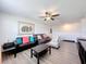 Spacious living room offers a ceiling fan and comfortable seating, ideal for gatherings and relaxation at 32101 Goddard Dr, Wesley Chapel, FL 33543