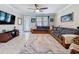 Comfortable living room features a ceiling fan, a large couch, a decorative rug, and a view of the outdoors at 32101 Goddard Dr, Wesley Chapel, FL 33543