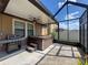 Covered patio featuring a grill, ceiling fan, and a hot tub for outdoor relaxation and entertainment at 32101 Goddard Dr, Wesley Chapel, FL 33543