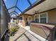 Covered patio with hot tub, grill, and outdoor seating area, perfect for relaxation and entertaining at 32101 Goddard Dr, Wesley Chapel, FL 33543