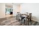 Open-concept dining area with hardwood flooring and views into the living area at 32779 Brooks Hawk Ln, Wesley Chapel, FL 33543