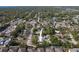 Wide aerial view of home near highway and community pond at 3451 Pine St, Dunedin, FL 34698
