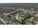 Aerial view of home in suburban neighborhood with pool at 3451 Pine St, Dunedin, FL 34698