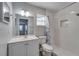 Bright bathroom offers a sleek vanity, framed mirror, tub/shower combo, and natural light at 3451 Pine St, Dunedin, FL 34698