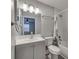 Bathroom with white vanity, shower-tub combo, and grey walls for a clean, modern aesthetic at 3451 Pine St, Dunedin, FL 34698