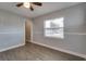 Bright bedroom with neutral walls, chair rail, wood-look floors, and large window at 3451 Pine St, Dunedin, FL 34698