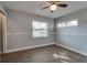 Bedroom featuring updated light fixture, wood-look floors, and a bright window at 3451 Pine St, Dunedin, FL 34698