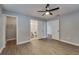 Bedroom boasts wood-look floors, walk-in closet, and connected bathroom, perfect for a primary suite at 3451 Pine St, Dunedin, FL 34698