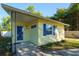Charming front exterior with blue shutters and front door at 3451 Pine St, Dunedin, FL 34698