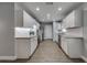 Open-concept kitchen design, showcasing white cabinets, stainless appliances, and modern flooring at 3451 Pine St, Dunedin, FL 34698