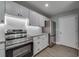This kitchen has sleek stainless appliances, bright white subway tile, and gray granite countertops at 3451 Pine St, Dunedin, FL 34698
