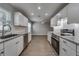 Bright kitchen with granite counters, stainless appliances, and seamless flow into living area at 3451 Pine St, Dunedin, FL 34698