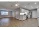Modern open-concept kitchen with white cabinets, stainless steel appliances, and wood-look flooring at 3451 Pine St, Dunedin, FL 34698
