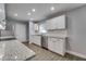 Bright kitchen boasts stainless steel appliances, sleek cabinets, and granite countertops at 3451 Pine St, Dunedin, FL 34698