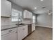 Stylish kitchen with stainless dishwasher and sink, paired with granite counters and tile backsplash at 3451 Pine St, Dunedin, FL 34698