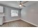 Cozy kitchenette area featuring granite countertops, white cabinets, and a bright window at 3451 Pine St, Dunedin, FL 34698