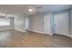 Bright living room features wood-look flooring, ceiling fan, and a large front door at 3451 Pine St, Dunedin, FL 34698