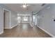 Inviting space with wood-look floors connects living room, kitchen, dining, and bathroom in an open layout at 3451 Pine St, Dunedin, FL 34698