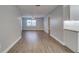Open living space with wood-look floors, neutral paint, ceiling fan, and windows with natural light at 3451 Pine St, Dunedin, FL 34698