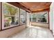 Bright sunroom featuring large windows, tiled floors, and a decorative wood ceiling at 3726 Prescott N St, St Petersburg, FL 33713