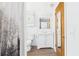 Bright bathroom features a toilet, vanity, and shower area with a stylish curtain, plus wood-look flooring at 39233 9Th Ave, Zephyrhills, FL 33542