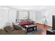 Cozy living room with hardwood floors, comfortable sofas, and a large window for natural light at 39233 9Th Ave, Zephyrhills, FL 33542