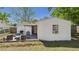 Back patio featuring a grill, chairs, an outdoor table, and an open layout at 39233 9Th Ave, Zephyrhills, FL 33542