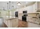 Modern kitchen features white cabinets, granite countertops, and stainless-steel appliances at 4205 57Th N Ave, St Petersburg, FL 33714
