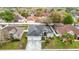 Overhead shot of the home with large three car garage, nice lawn, and a gray roof at 4262 Larkenheath Dr, Spring Hill, FL 34609