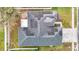 Overhead view displays house with solar panels, fenced yard, and nearby street access at 4262 Larkenheath Dr, Spring Hill, FL 34609