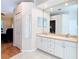 Well-lit bathroom with double sink vanity, tiled floors and a neutral color palette at 4262 Larkenheath Dr, Spring Hill, FL 34609