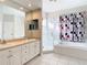 Bathroom featuring double sinks, a glass-enclosed shower, and a soaking tub at 4262 Larkenheath Dr, Spring Hill, FL 34609