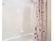 Bathroom featuring a white tiled shower/tub combo with a shower head and floral shower curtain at 4262 Larkenheath Dr, Spring Hill, FL 34609