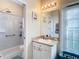 Bright bathroom featuring a shower, vanity with ample lighting, and a large mirror at 4262 Larkenheath Dr, Spring Hill, FL 34609