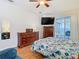 Bedroom featuring a bed, wood floors, dresser, and sliding doors to a patio at 4262 Larkenheath Dr, Spring Hill, FL 34609
