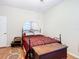Bedroom featuring a full bed, a trunk, and a vanity with a mirror, ideal for relaxation at 4262 Larkenheath Dr, Spring Hill, FL 34609