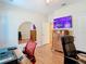 Bedroom featuring hardwood floors, office space, and a large dresser with a mounted television at 4262 Larkenheath Dr, Spring Hill, FL 34609