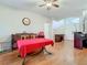 Bright dining area with hardwood floors, ceiling fan, and convenient access to the front entrance at 4262 Larkenheath Dr, Spring Hill, FL 34609
