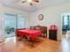 Inviting dining room with hardwood floors, ceiling fan, and access to the outdoor patio at 4262 Larkenheath Dr, Spring Hill, FL 34609