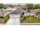 Well-maintained home with a three-car garage, manicured lawn, and solar panels for energy efficiency at 4262 Larkenheath Dr, Spring Hill, FL 34609