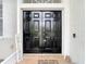 Elegant double front doors with welcome mat, inviting entrance to a well-kept home at 4262 Larkenheath Dr, Spring Hill, FL 34609
