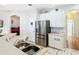 Kitchen view featuring stainless steel refrigerator, marble flooring, and white cabinets at 4262 Larkenheath Dr, Spring Hill, FL 34609