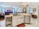 Open concept kitchen with a view of the living room featuring marble floors and white cabinetry at 4262 Larkenheath Dr, Spring Hill, FL 34609