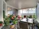 Outdoor lanai with a dining table, multiple plants, and access to the backyard at 4262 Larkenheath Dr, Spring Hill, FL 34609