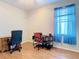 Bright office space featuring hardwood flooring, a desk, and a comfortable office chair at 4262 Larkenheath Dr, Spring Hill, FL 34609