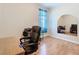 Home office with wood laminate flooring, chair, and a large arched mirror at 4262 Larkenheath Dr, Spring Hill, FL 34609