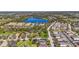 An aerial view of the neighborhood, with lush trees surrounding a lake, residences, and green spaces at 4811 Forest Creek Trl, Parrish, FL 34219