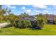 Spacious backyard featuring a screened-in lanai surrounded by lush tropical landscaping at 4811 Forest Creek Trl, Parrish, FL 34219